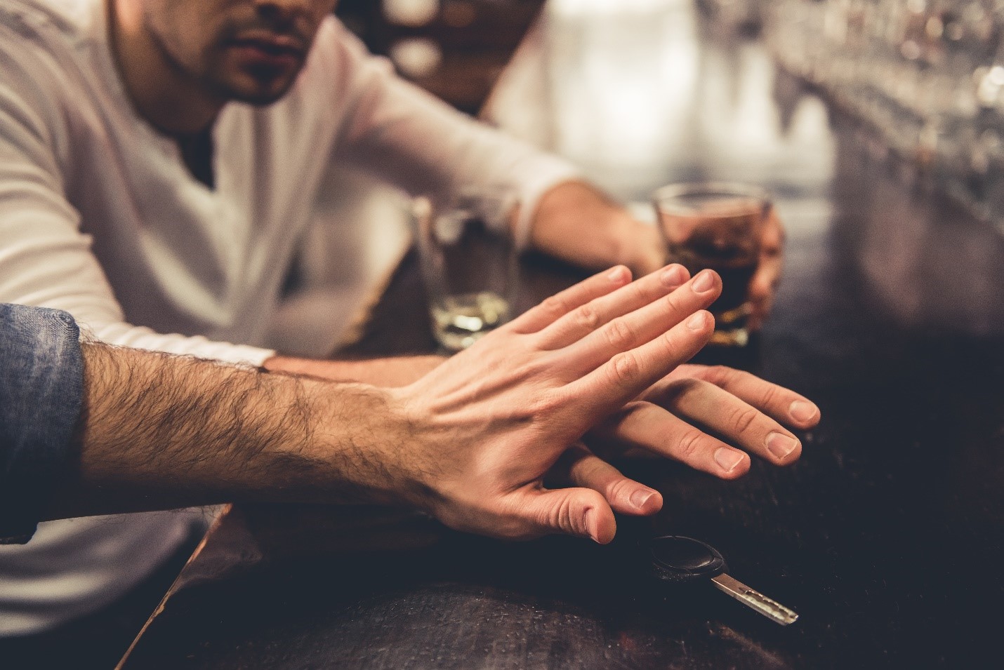 Responsible driver stopping a friend from drunk driving