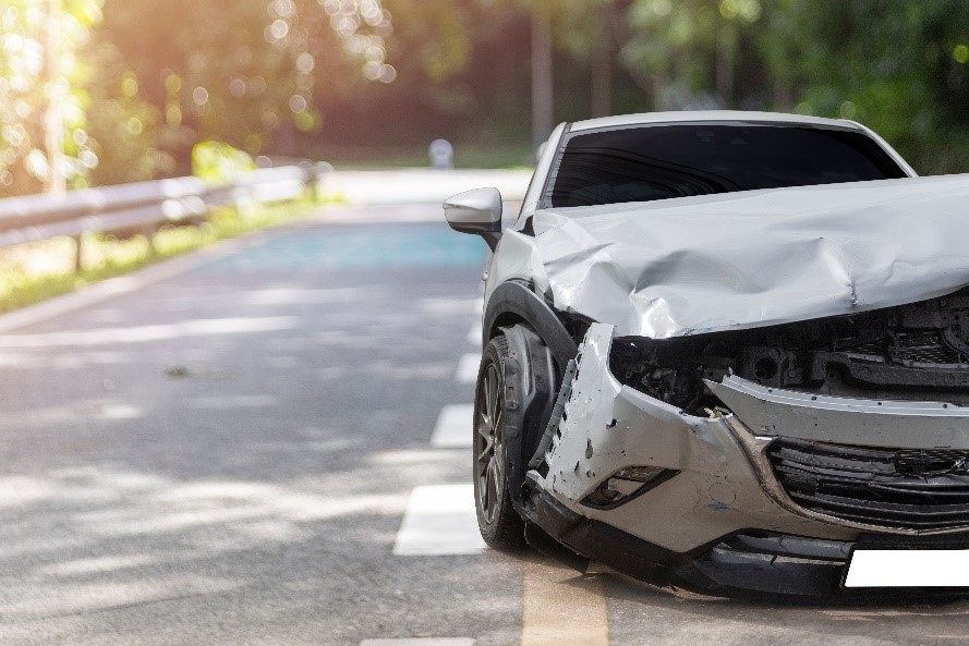 Wrecked car along the side of the road following a hit and run.