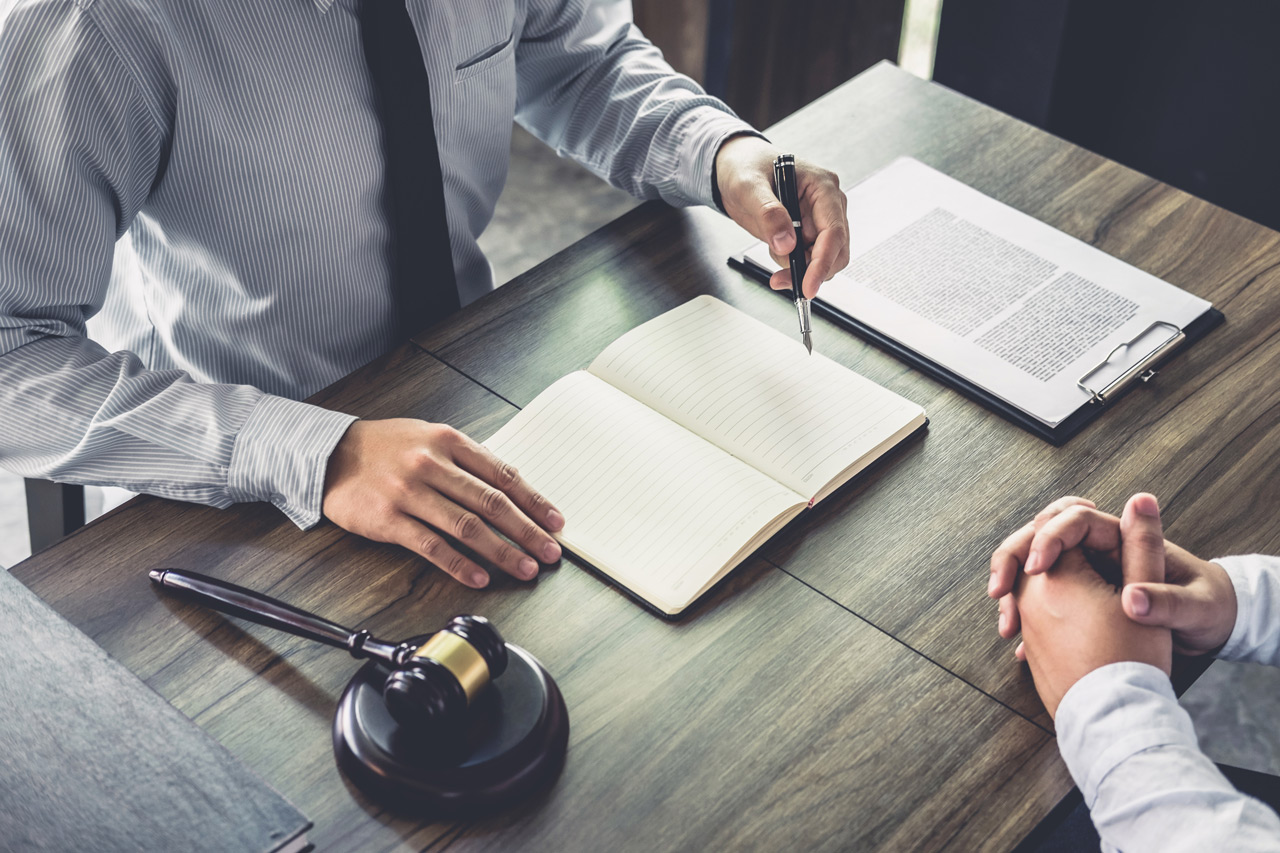 lawyer writing at desk