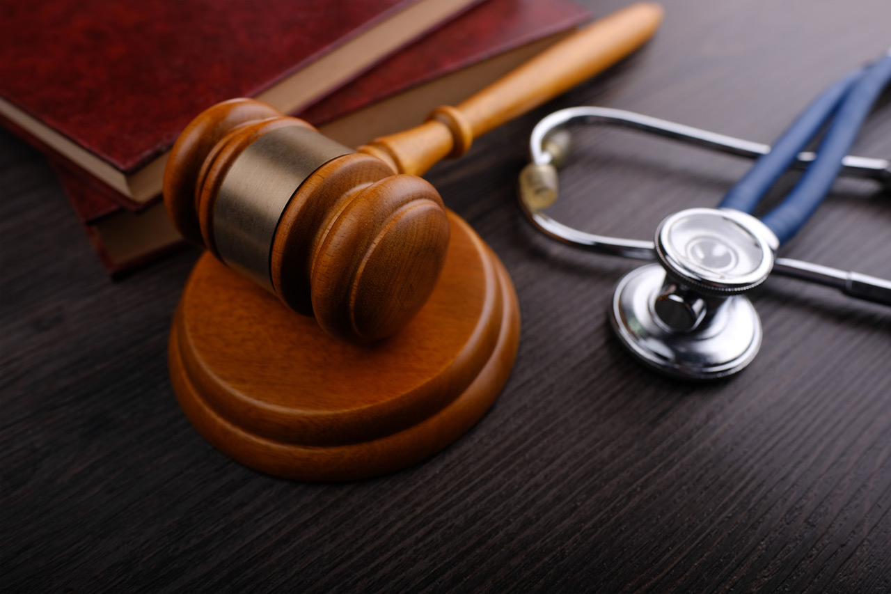 gavel and stethoscope on a desk