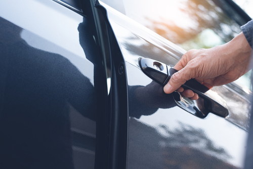 man opening a car door