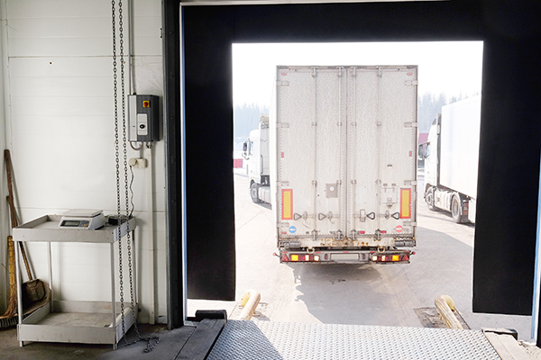 A truck is driving away from a loading dock