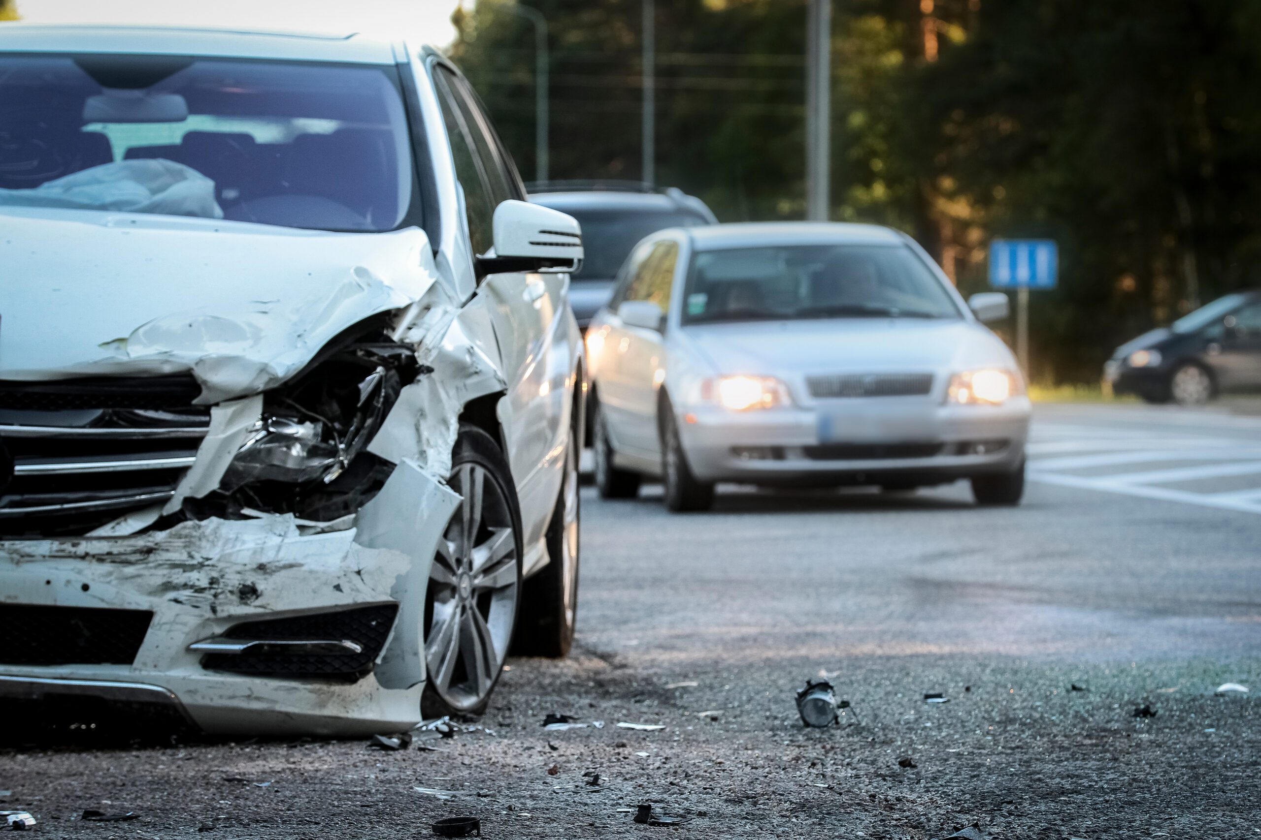 wrecked car with other stopped cars in the background