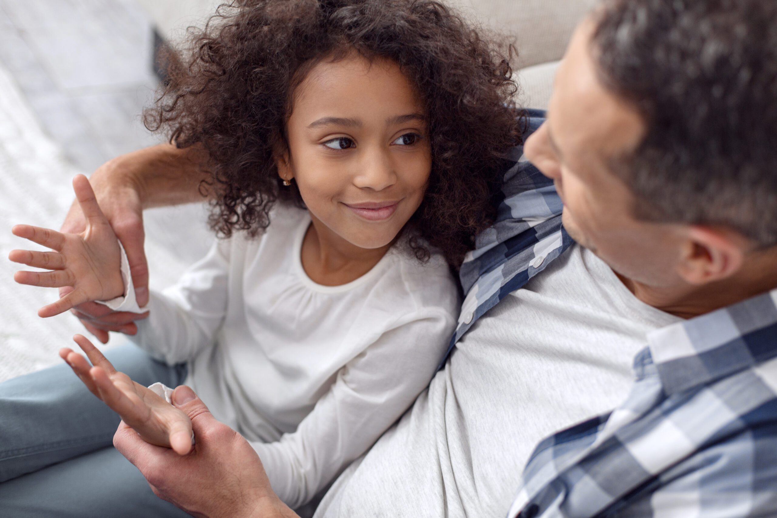 young girl and middle-aged man smiling and talking