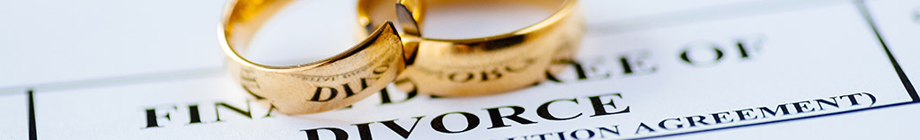 Two rings sit on top of divorce paperwork.